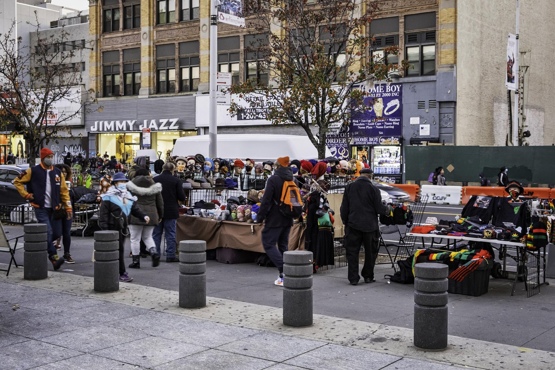 People walking and shopping around African Square in Harlem, Manhattan