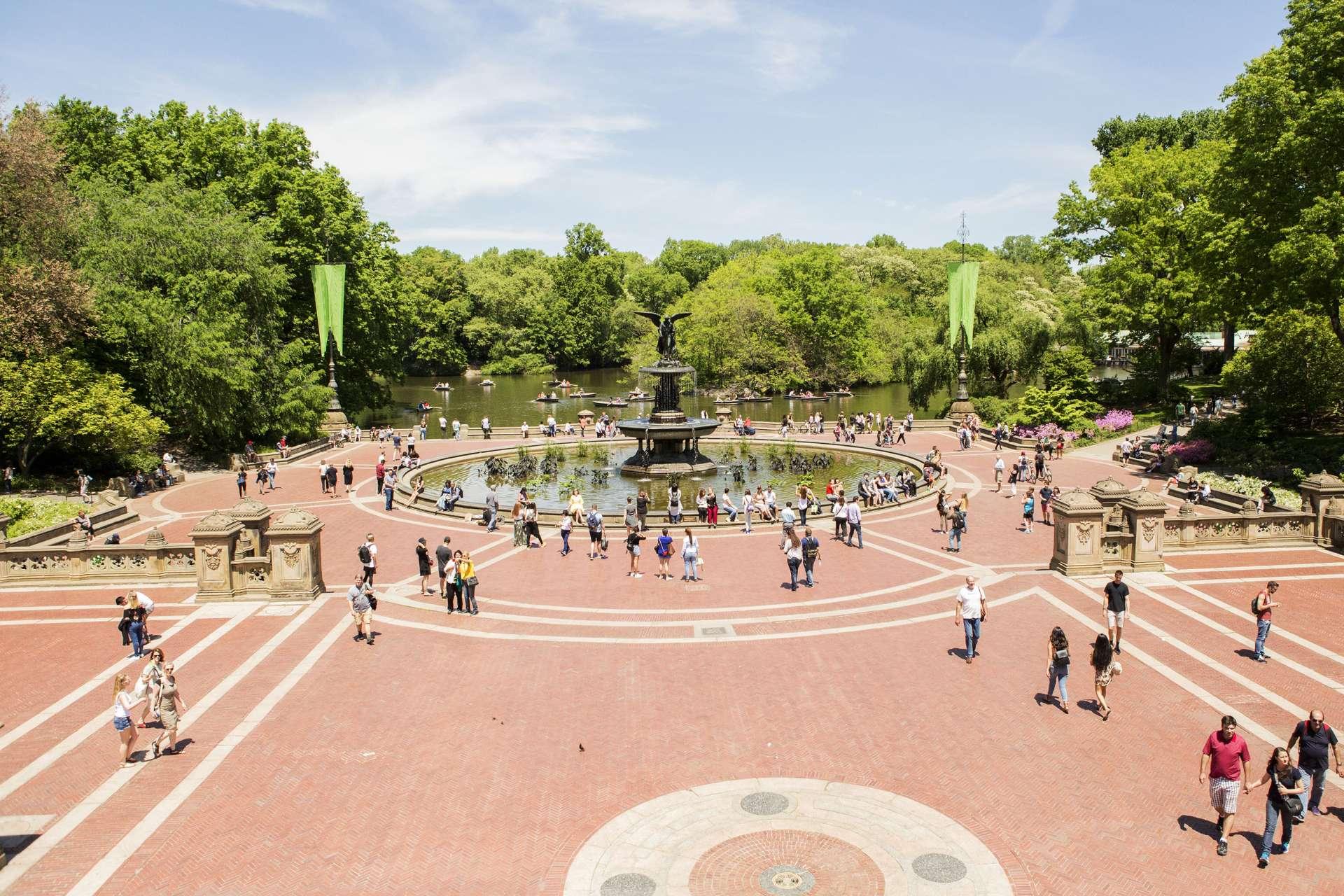 People walk around Bethesda Fountain in Central Park in Manhattan