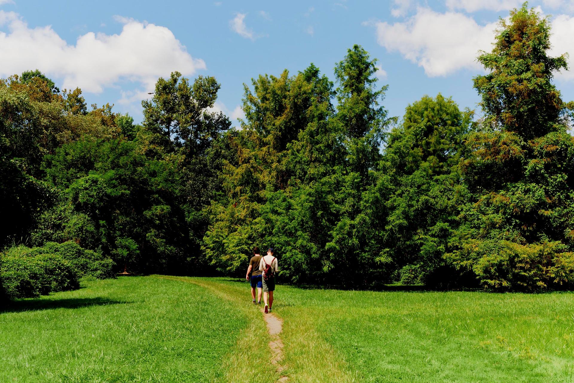 Two people walking in Snug Harbor Cultural Center, & Botanical Garden